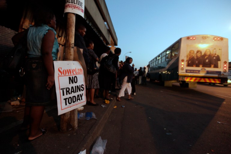 Commuters in South Africa wait for public transport
