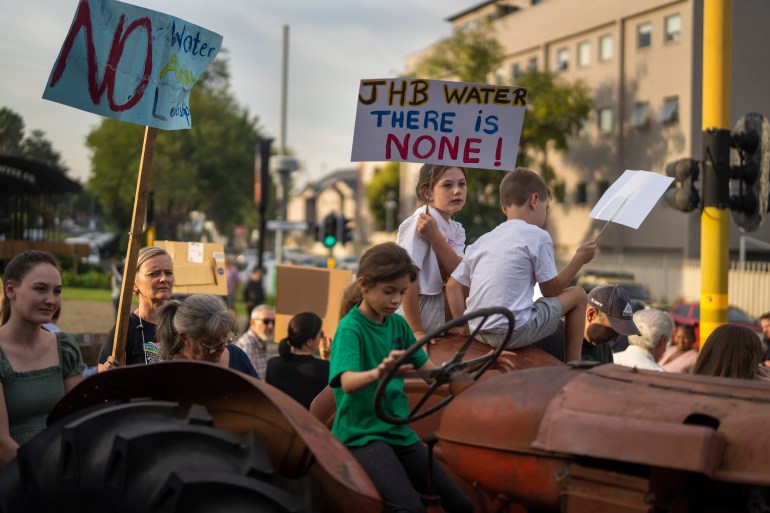 Children with protest signs against water cuts in South Africa