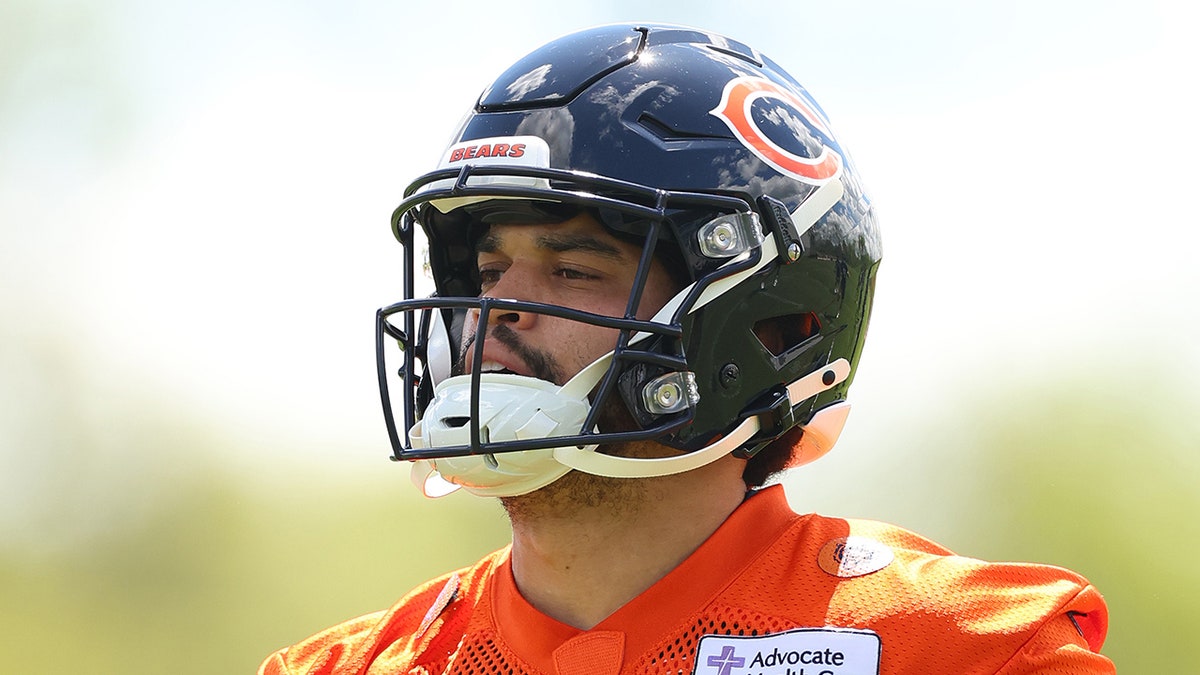 Caleb Williams runs on field