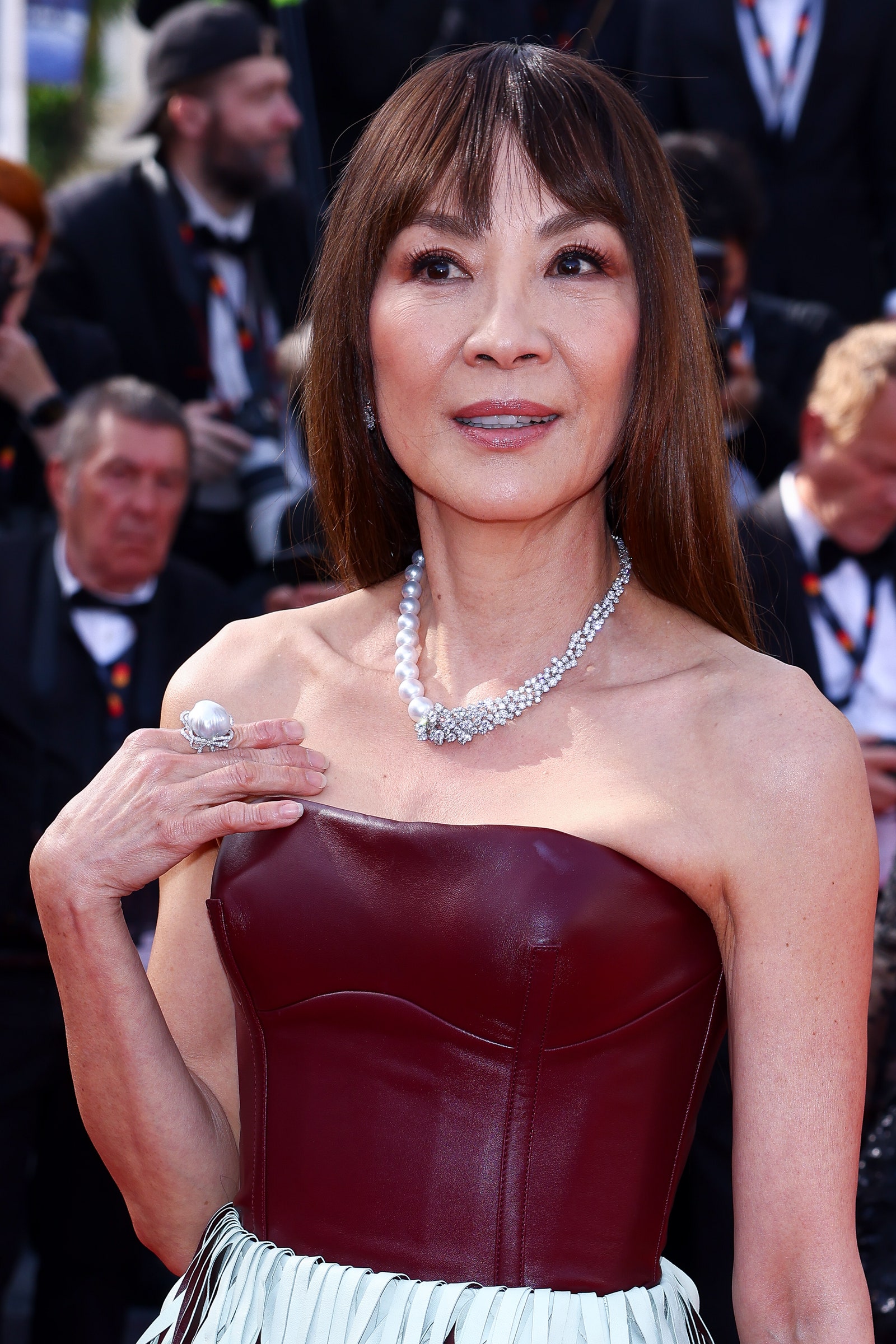 Image may contain Michelle Yeoh Accessories Jewelry Ring Clothing Hat Fashion Necklace Adult Person and Wedding