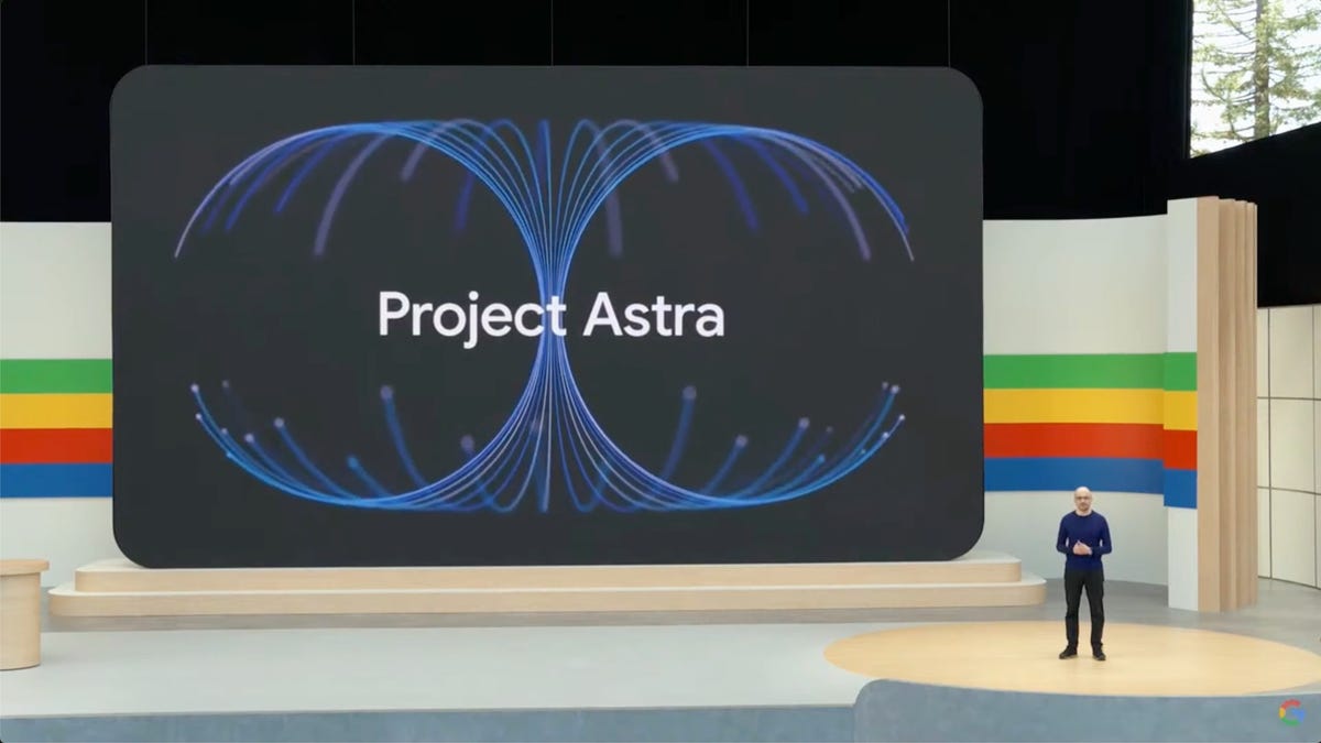 A large on-stage screen showing the words