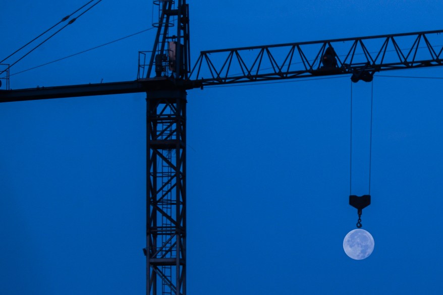 Flower Moon with a hook of a crane in Dakar, Senegal.