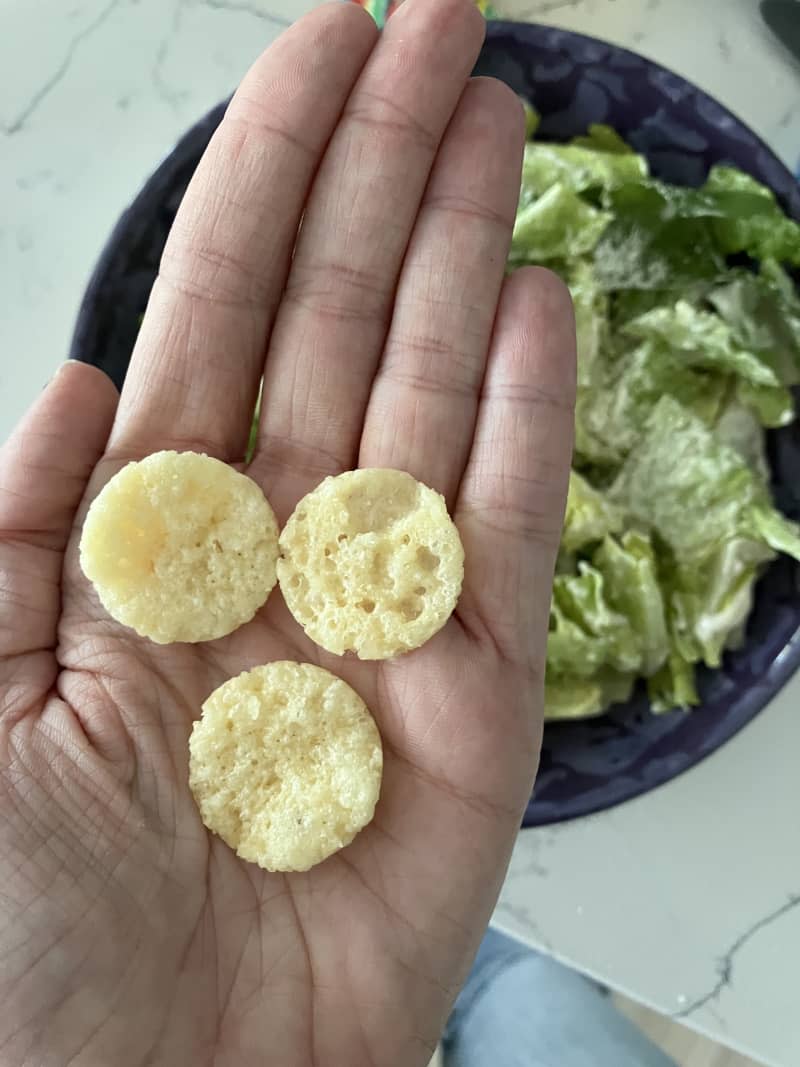 Mrs. Cubbison's Cheese Crisps held in a hand.
