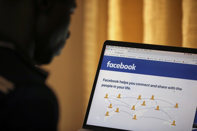 A man looks at Facebook