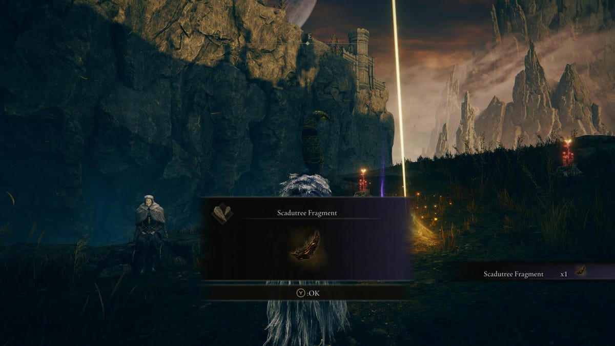 A game character picking up a Scadutree Fragment item in front of a bright yellow cross on a ridge.