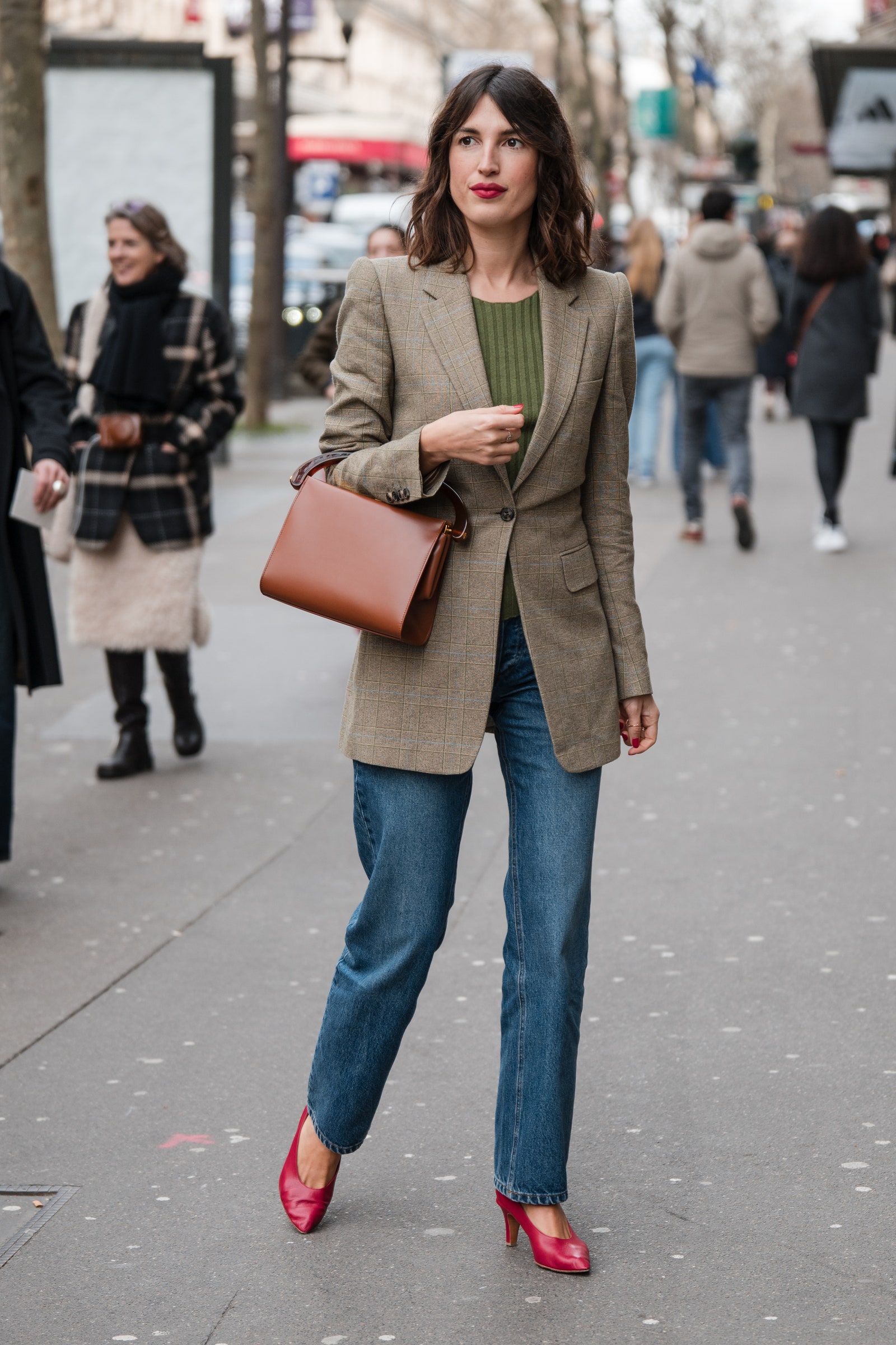 PARIS FRANCE FEBRUARY 28 Jeanne Damas wears green top beige checked blazer jeans brown bag red heels outside Dries Van...