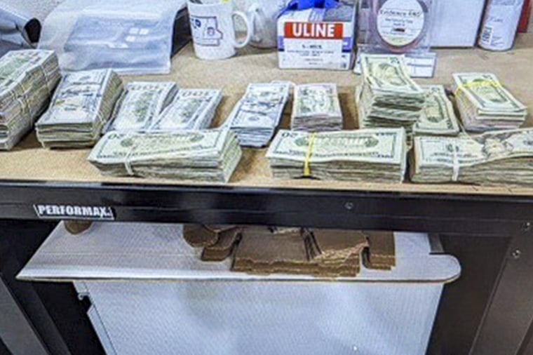 Cash from a bag set in a desk.