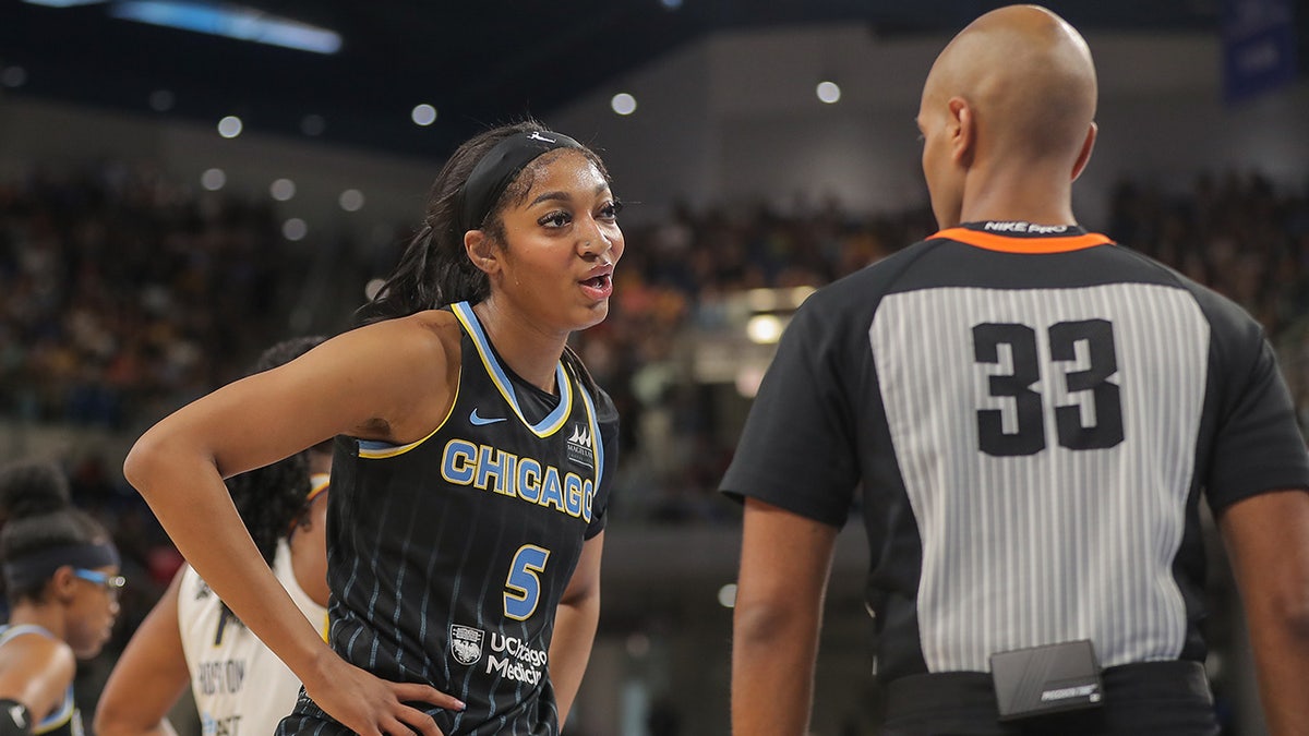 Angel Reese talks to a ref