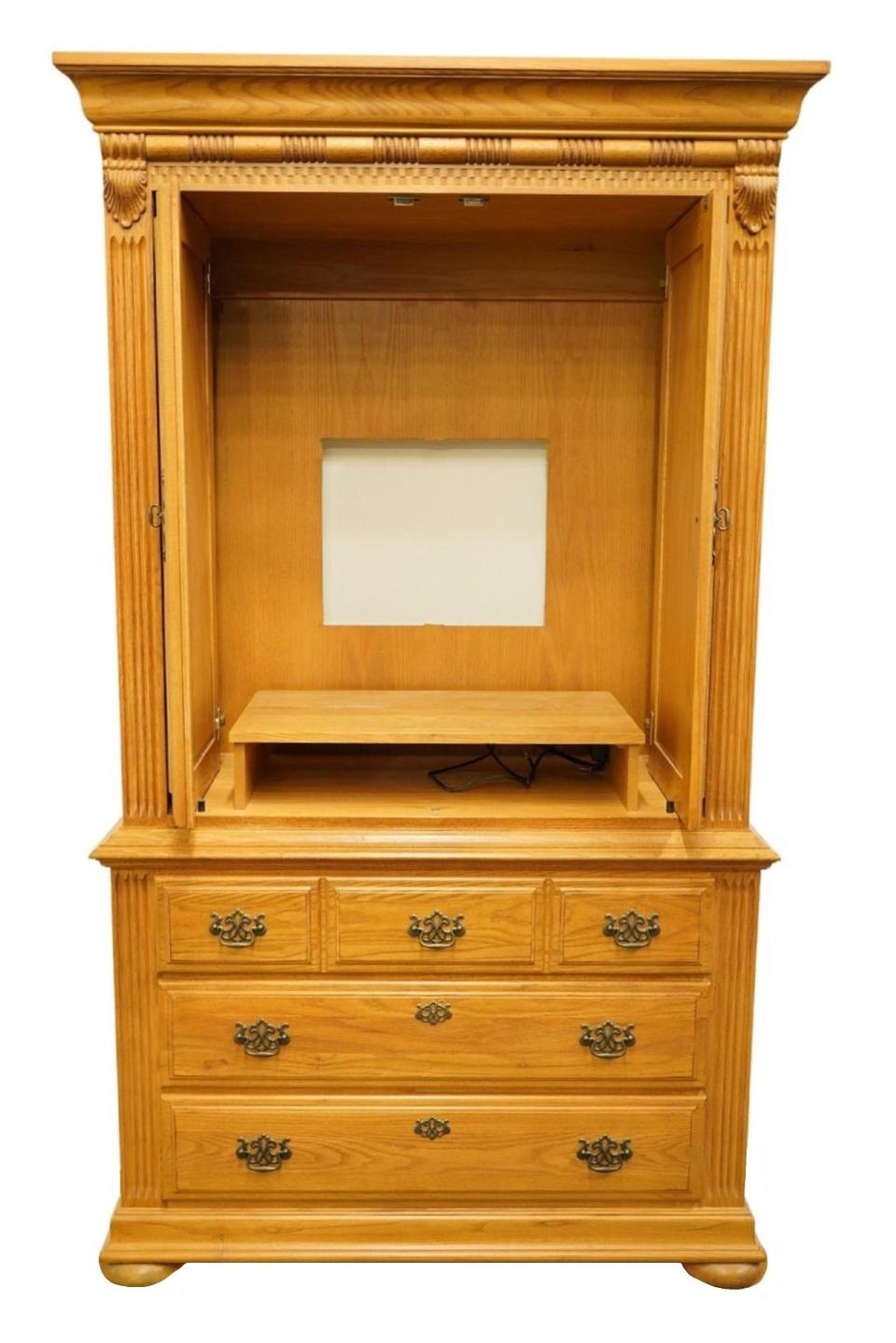 Close-up of an empty blonde wood armoire with no TV
