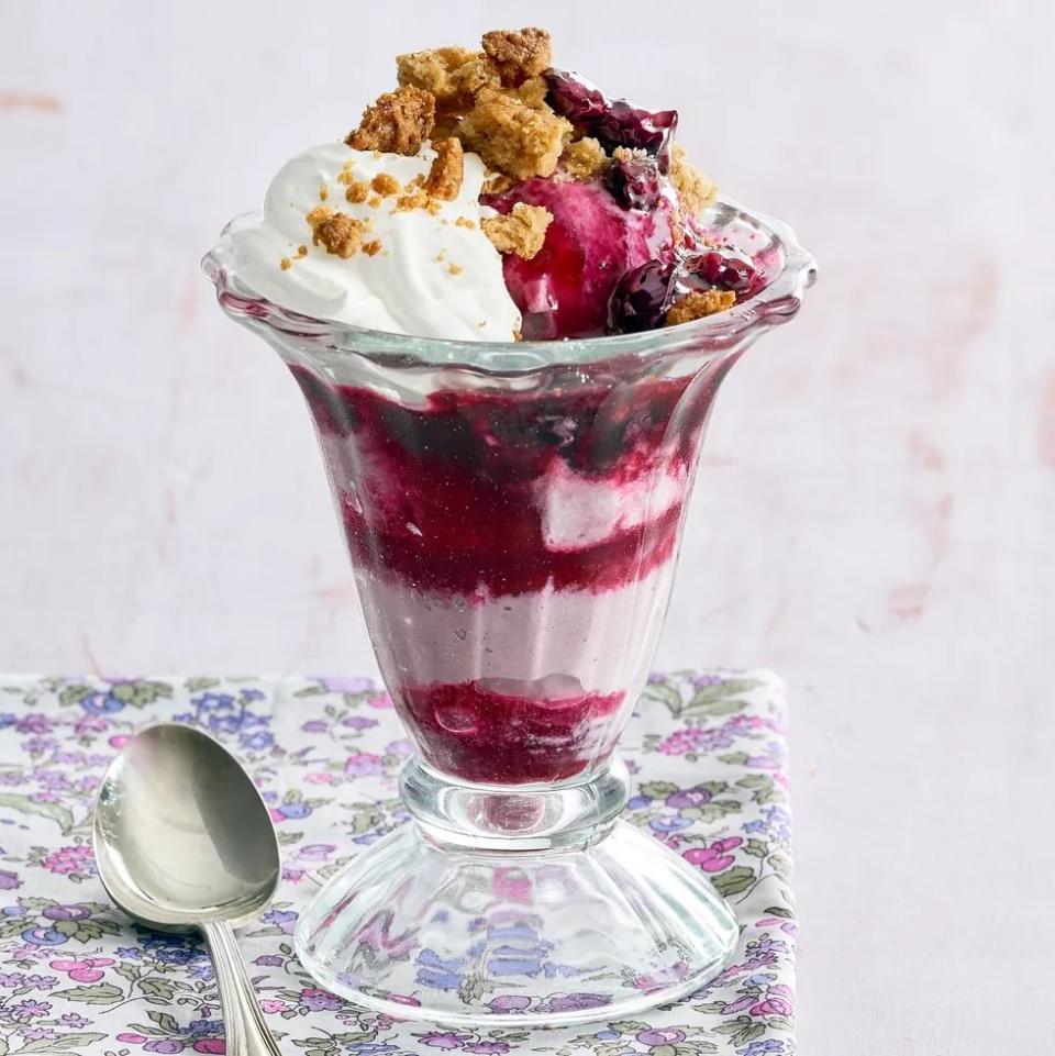 blueberry crumble sundaes in tall sundae glass on purple floral napkin