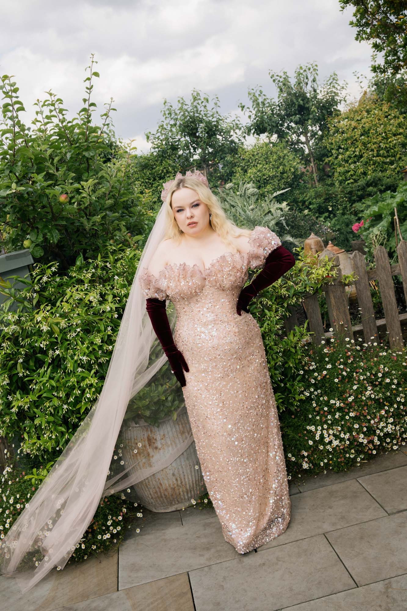 Image may contain Clothing Dress Fashion Formal Wear Gown Wedding Wedding Gown Nature Outdoors Yard and Glove