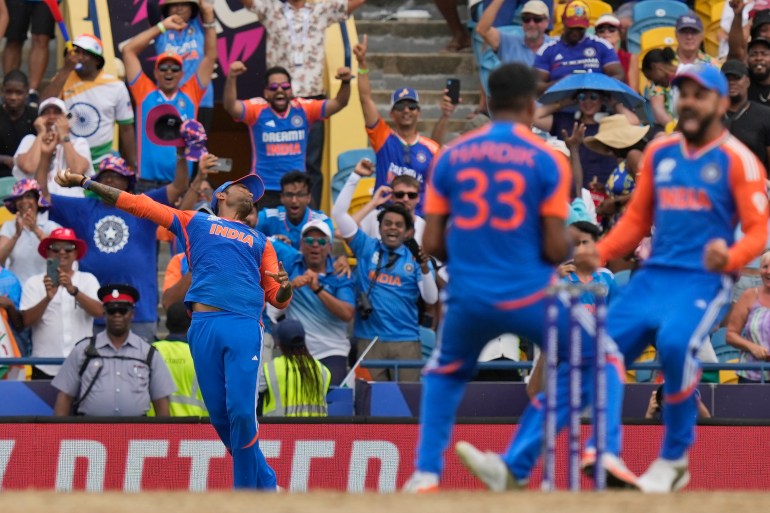 India's Suryakumar Yadav, left, takes the catch to get South Africa's David Miller out as teammates Virat Kohli, right, and Hardik Pandya celebrate during the ICC Men's T20 World Cup final cricket match between India and South Africa at Kensington Oval in Bridgetown, Barbados, Saturday, June 29, 2024. (AP Photo/Ramon Espinosa)