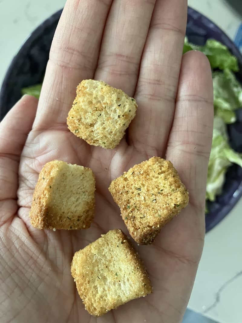 Mrs. Cubbison's Classic Seasoned Croutons in a hand.