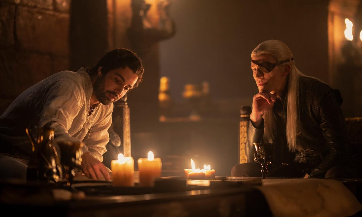 aemond and criston sit and plot at the castle in house of the dragon