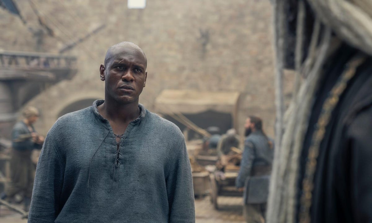 man at the docks looks at corlys velaryon in house of the dragon