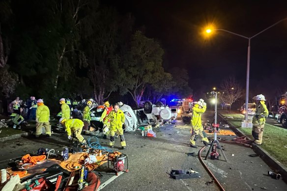 Emergency workers at the scene of the two-car crash at Forest Lake.