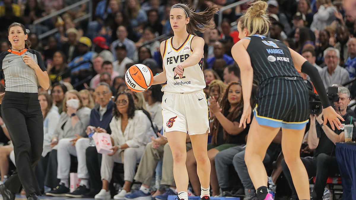 Caitlin Clark points out a play