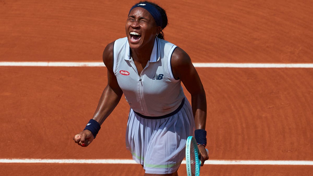 Tennis player Coco Gauff celebrating, shouting with eyes closed.