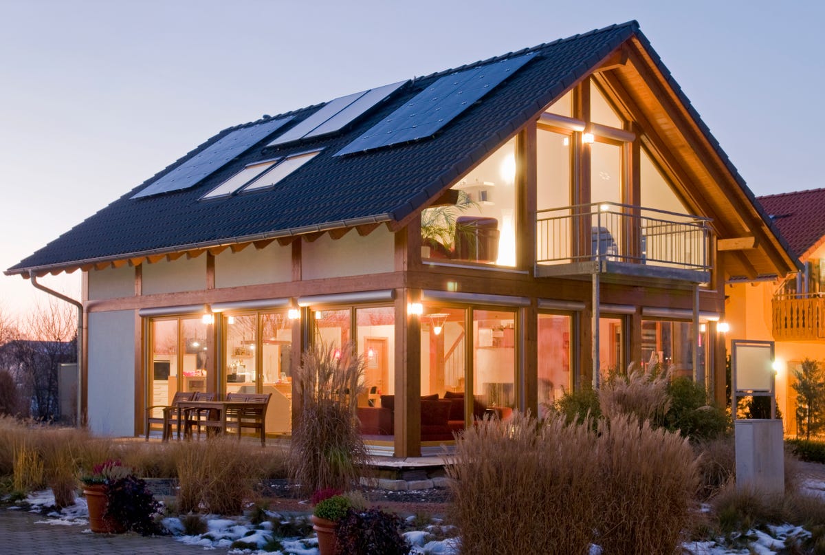 House with solar panels lit up at dusk