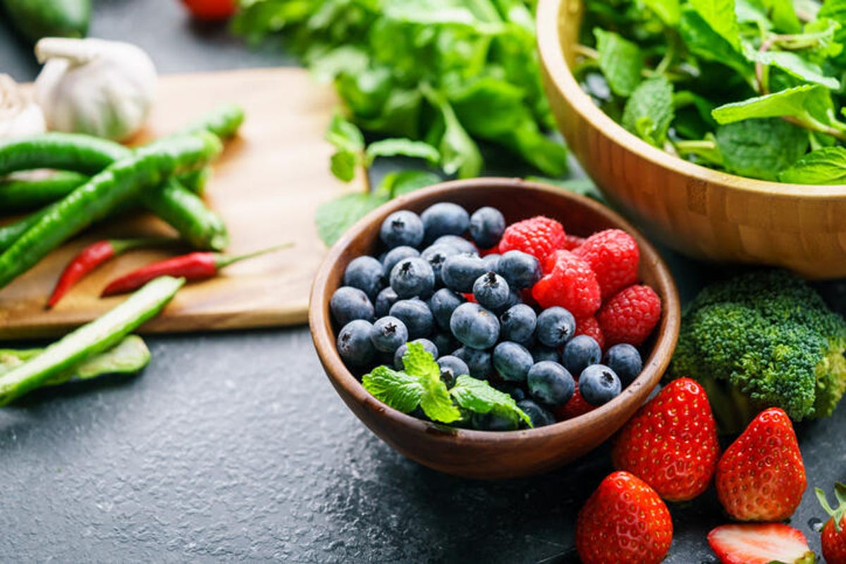 fruits and vegetables in bowls on table