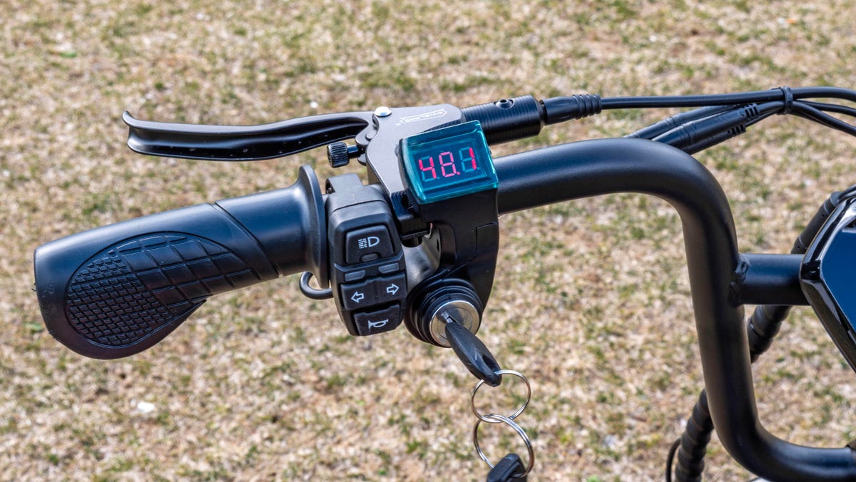 The left handlebar of the HappyRun Tank G60 e-bike has a voltage display, key start and controls for the headlight, horn and turn signals.