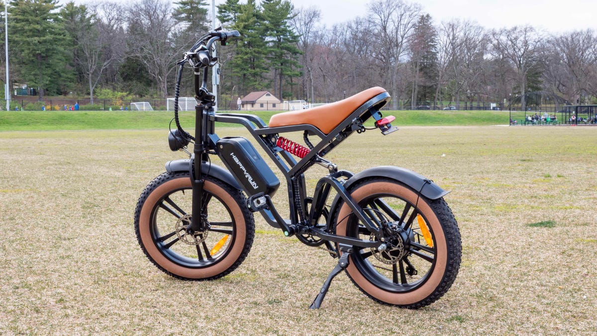 HappyRun Tank G60 e-bike right side standing in a field with trees in the background.