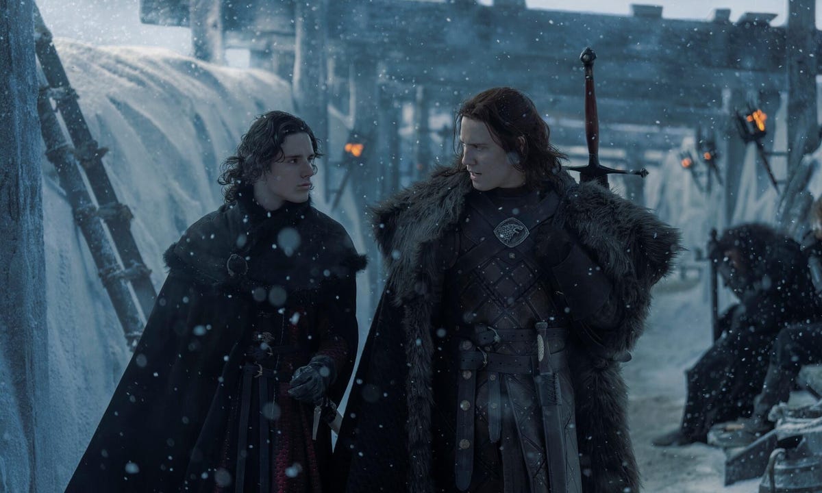 two men dressed in cloaks in snow in house of the dragon