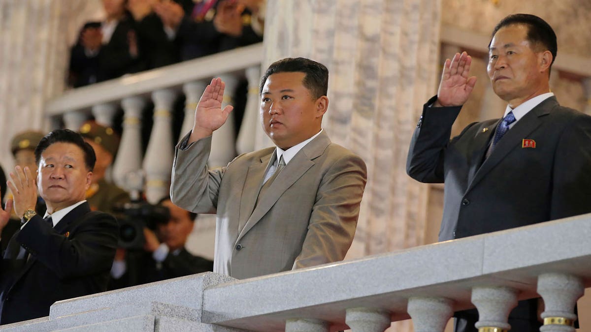 North Korean leader Kim Jong Un, center, waves from a balcony toward the assembled troops and spectators during a celebration of the nation’s 73rd anniversary at Kim Il Sung Square in Pyongyang, North Korea, on Sept. 9, 2021.