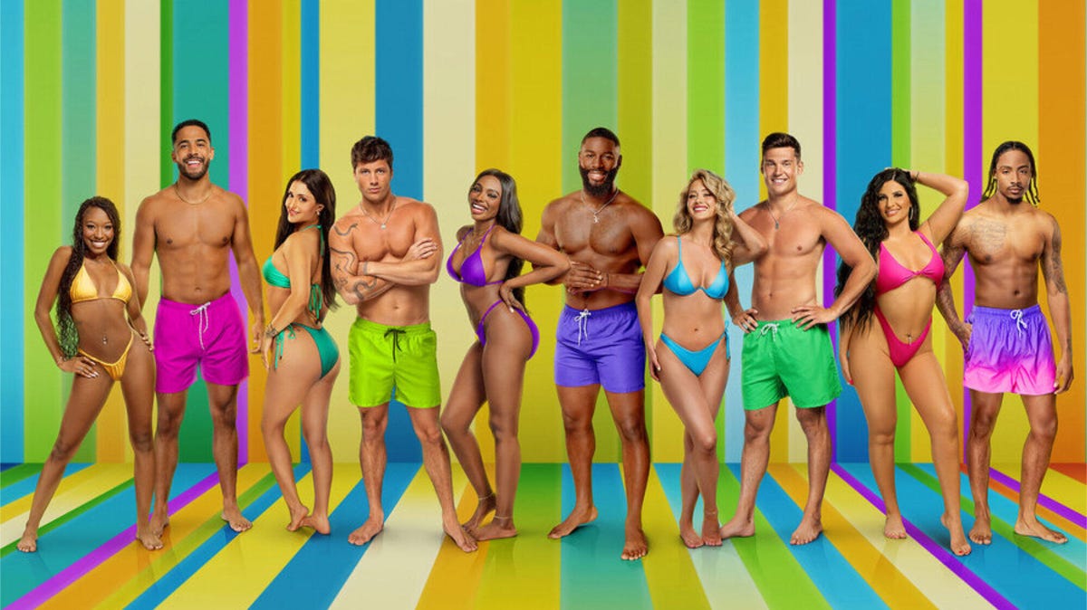 The Cast of Love Island USA Season 6 standing in front of a multicoloured background.