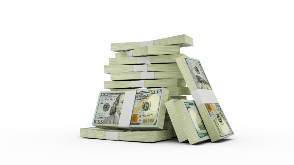 Stacks of hundred-dollar bills arranged in piles