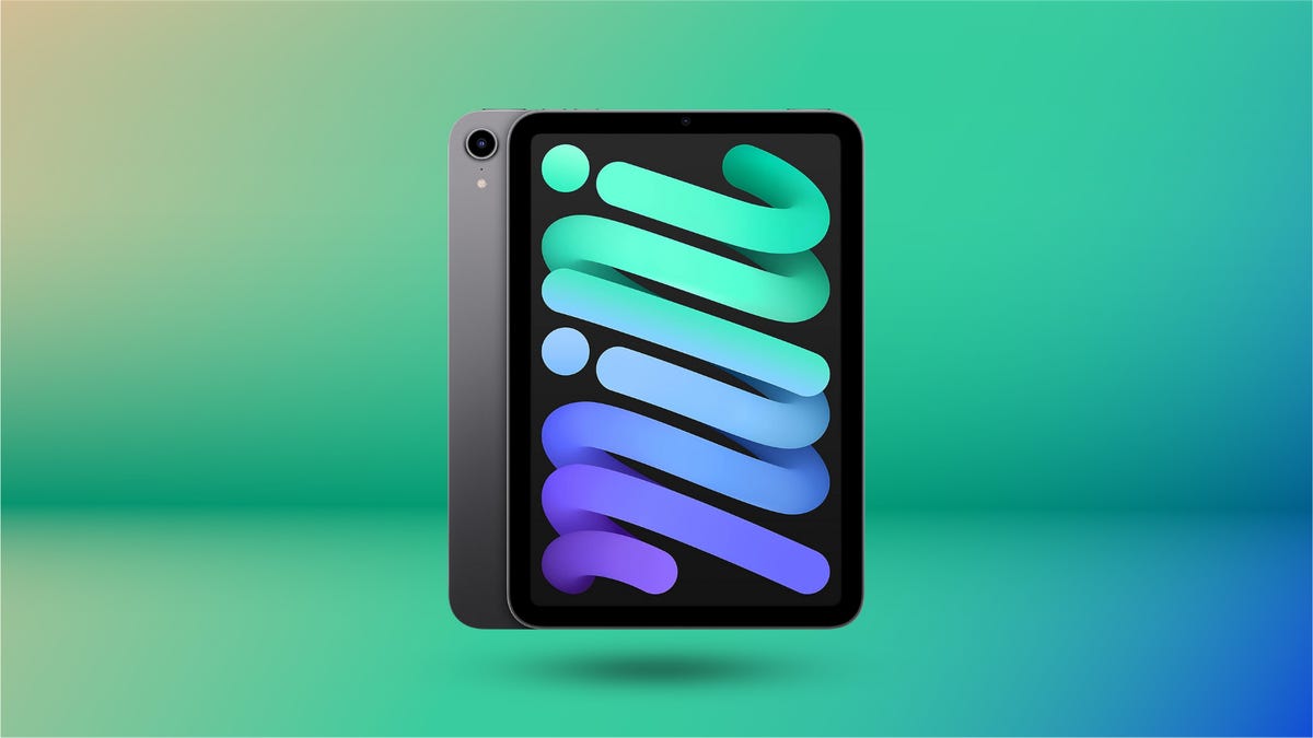 Apple iPad mini 6th generation in Space Gray displayed against green and blue gradient background.