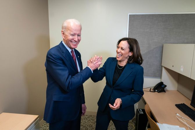 Harris and Biden greet each other at a Detroit high school as they attend a