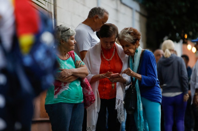 People queue outside a polling station in Venezuela