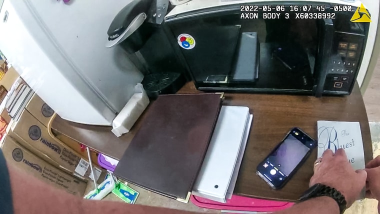 Body cam footage from senior deputy constable Scott London photographing library books as part of his investigation
