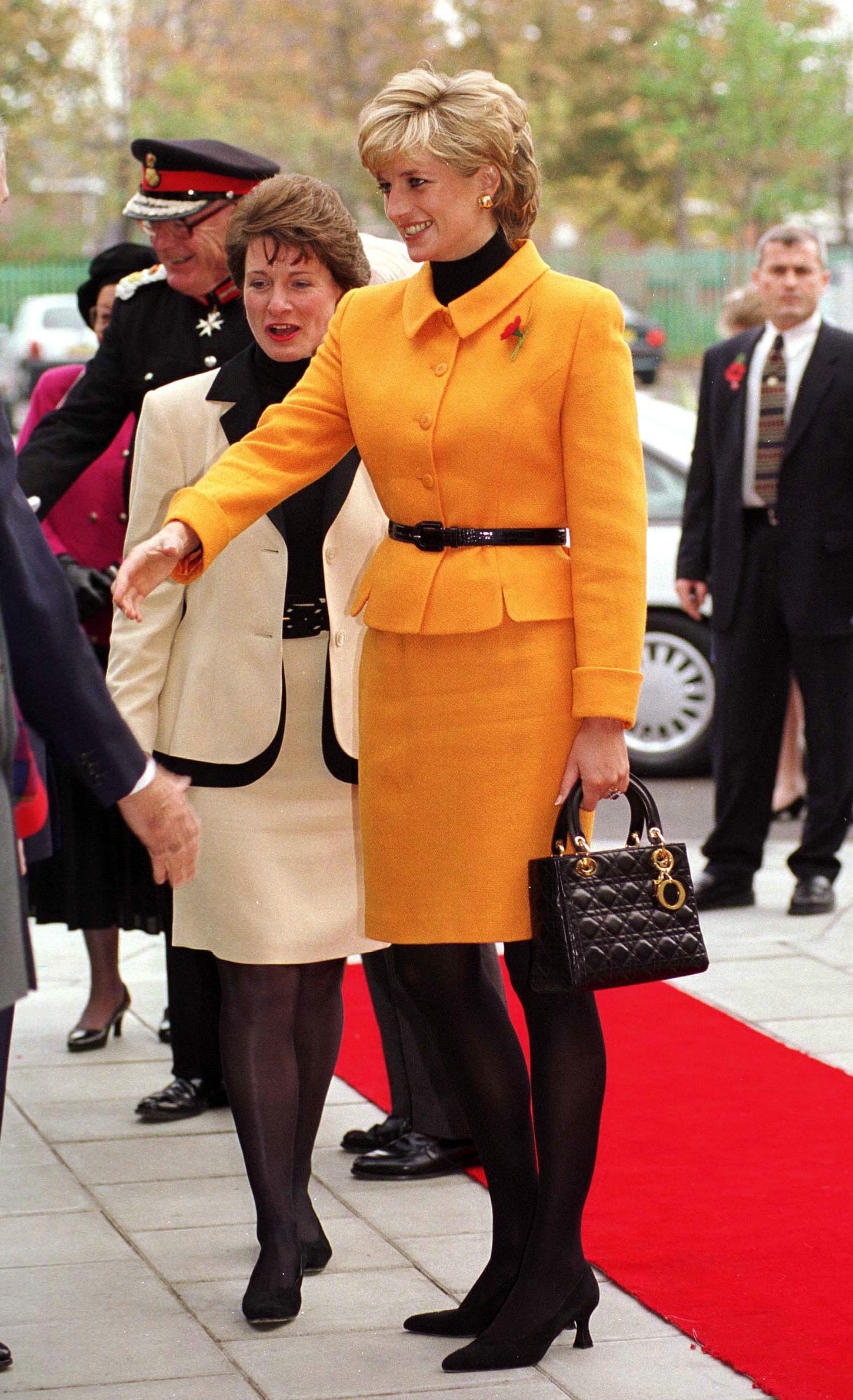 LIVERPOOL UNITED KINGDOM NOVEMBER 07 Princess Diana Visiting Liverpool. Diana Is Wearing A Bright Orange Suit Designed...