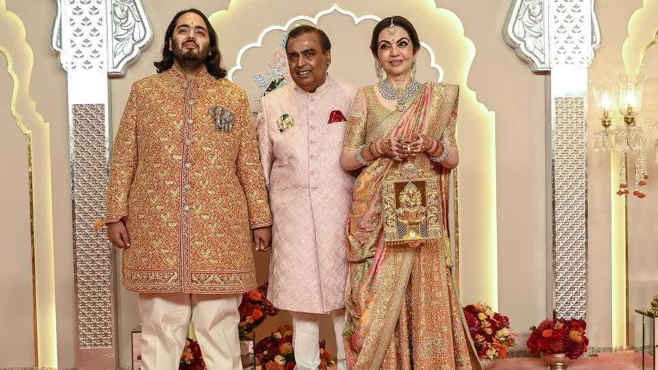 From left to right, Anat Ambani alongside his father Mukesh Ambani and mother Nita, whose dress took artisans 40 days to handcraft. - Sujit Jaiswal/AFP/Getty Images