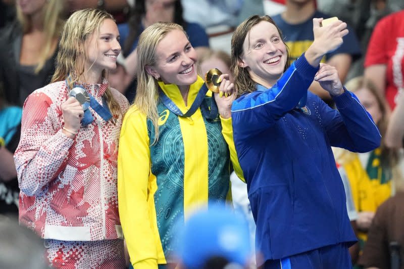 Gold medalist Ariarne Titmus of Australia (C), silver medalist Summer McIntosh of Canada (L) and bronze medalist Katie Ledecky of the U.S. celebrate on the podium after the women's 400-meter freestyle final at the Paris Olympics on Saturday at La Defense Arena in Paris. Photo by Richard Ellis/UPI