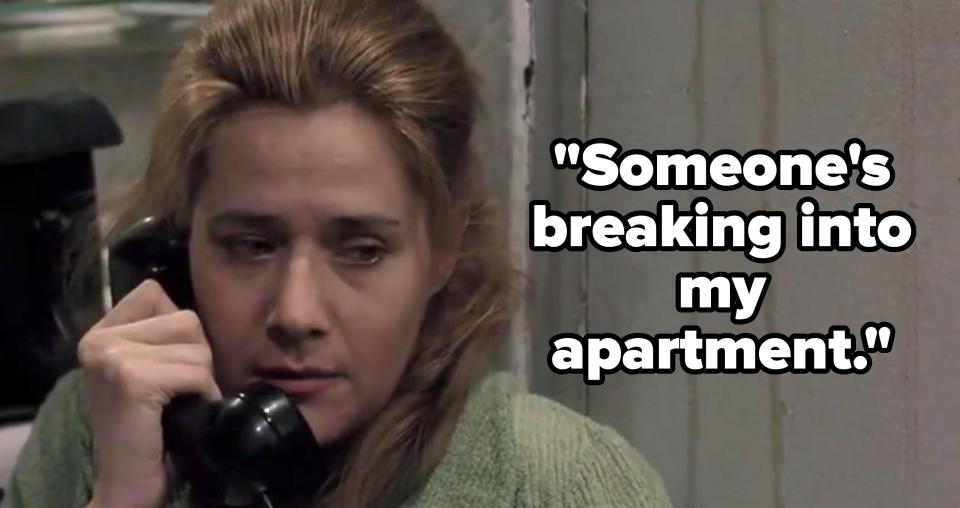 A woman with light brown hair is holding a black telephone handset to her ear while looking concerned