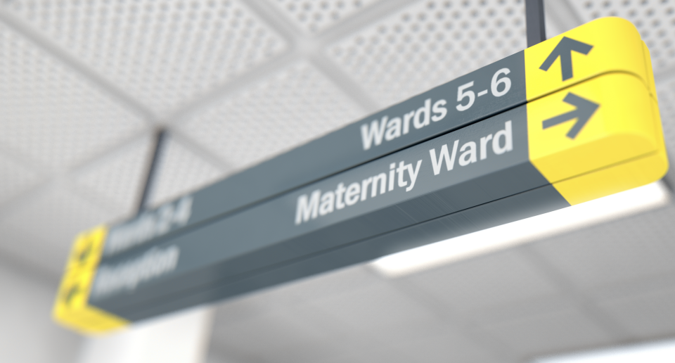 Hospital sign showing directions to Reception, Wards 5-6, and Maternity Ward