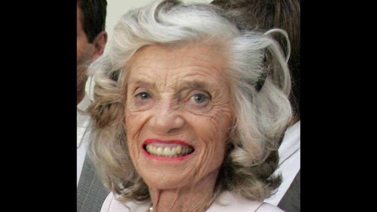 Handicaped swimmer Annet Lange, left, shows to Eunice Kennedy Shriver, right, sister of former US President John F. Kennedy, and her son Anthony, center, her gold and silver medals, which she won at the Special Olympics 2003 in Ireland, during a visit of the Kennedy's to a factory where all workers are handicaped, in Berlin Wednesday, June 22, 2005. The Kennedy's are making a three-day visit to Germany. (AP Photo/Roberto Pfeil)