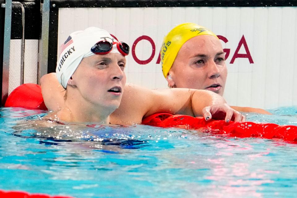 The USA's Katie Ledecky and Australia's Ariarne Titmus check their times in the women’s 400-meter freestyle prelims on Saturday. Both advanced to an expected showdown in the final.
