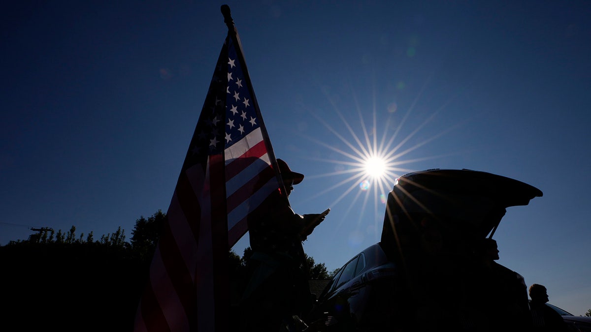 People wait for the funeral procession for Corey Comperatore