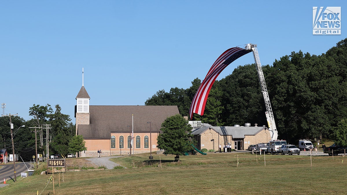 Members of the community mourn the death of Corey Comperatore on the morning of his funeral at Cabot United Methodist Church
