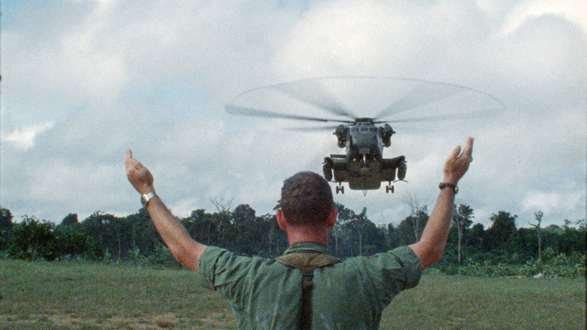 A military air traffic controller directs a helicopter landing in Guyana.