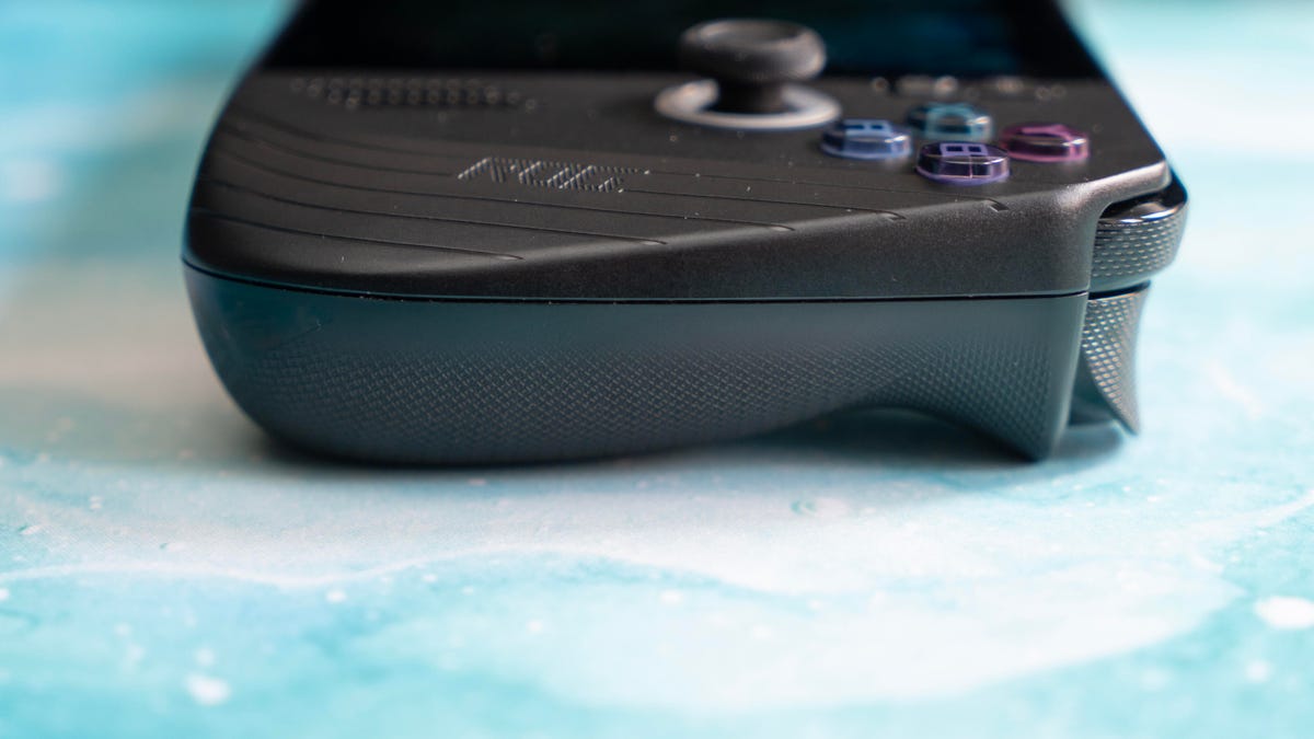 The Ally X from the side showing the grip on a turquoise marbled background