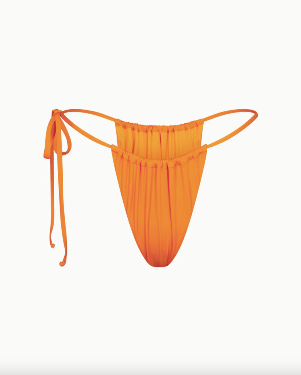 <p><a href="https://www.khy.com/products/ruched-tie-bikini-bottom-sunset" rel="nofollow noopener" target="_blank" data-ylk="slk:Shop Now;elm:context_link;itc:0;sec:content-canvas" class="link ">Shop Now</a></p><p>Ruched Tie swimsuit Bottom</p><p>khy.com</p><p>$34.00</p>