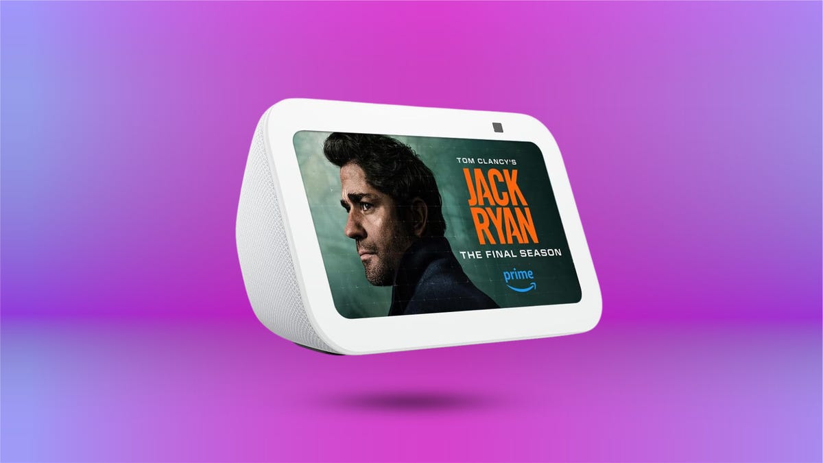 Amazon's Echo Show 5 smart speaker in white displayed against purple gradient background.