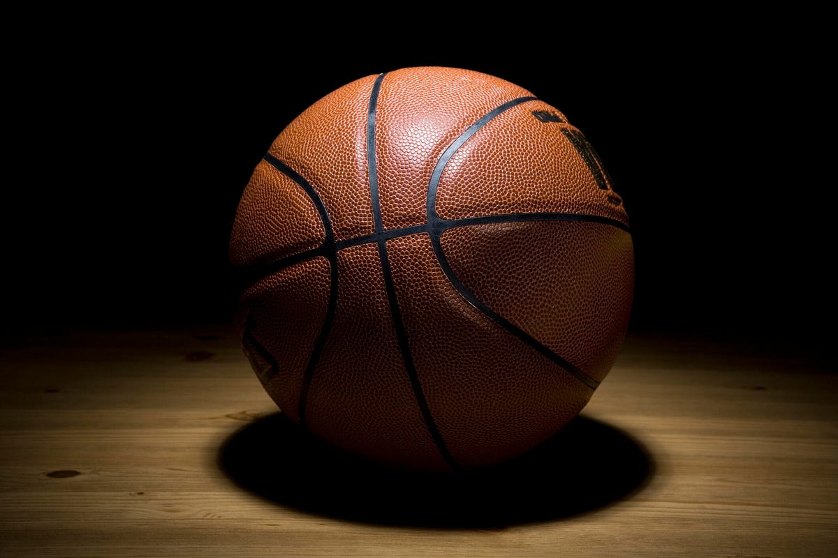 A basketball against a dark stage
