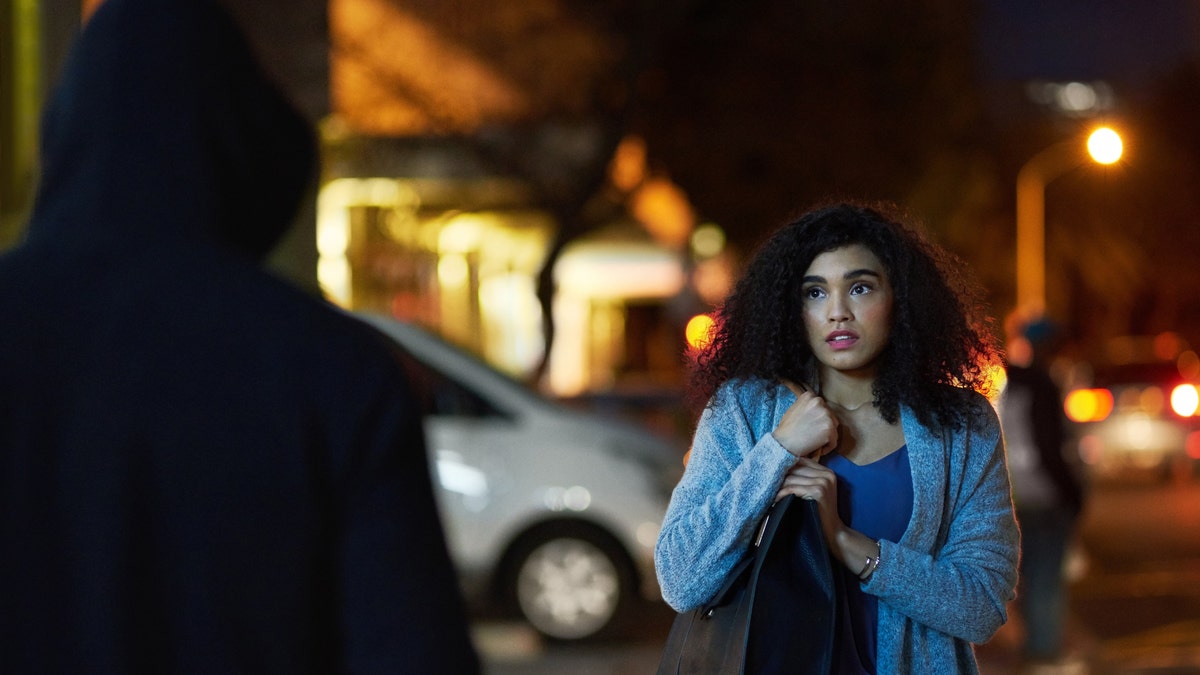 A woman at night face to face with criminal