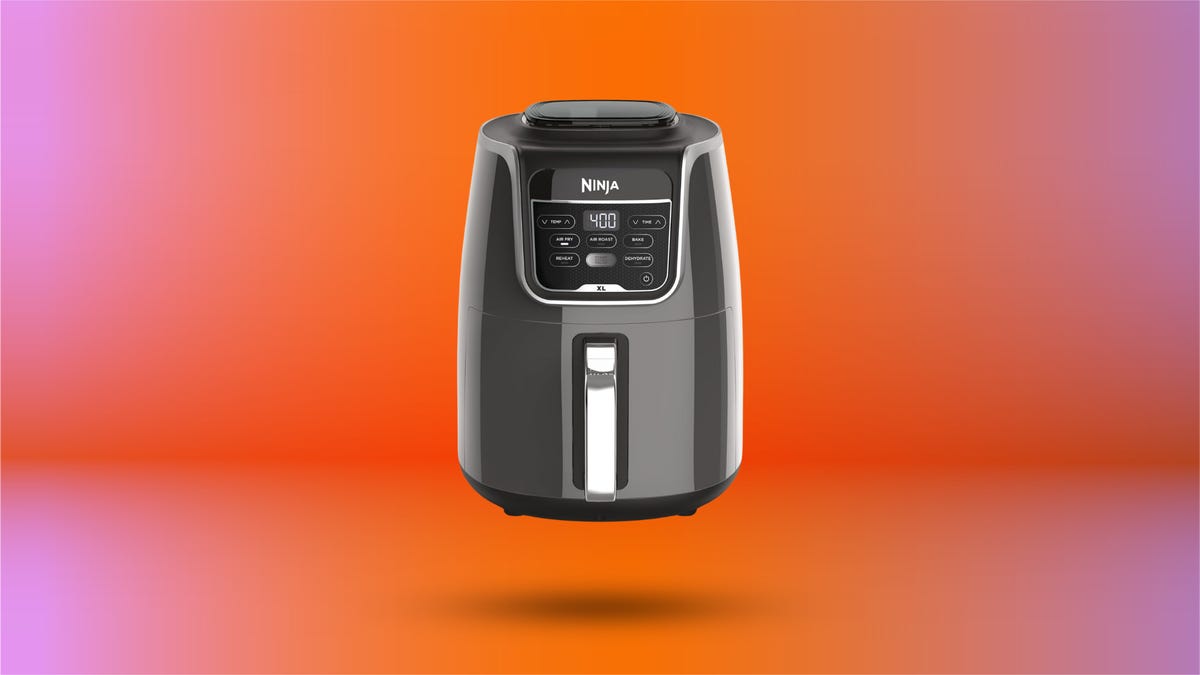Ninja Air Fryer on display against orange gradient background.